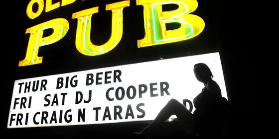 The illuminated Olde City Pub sign listing the week's entertainment.