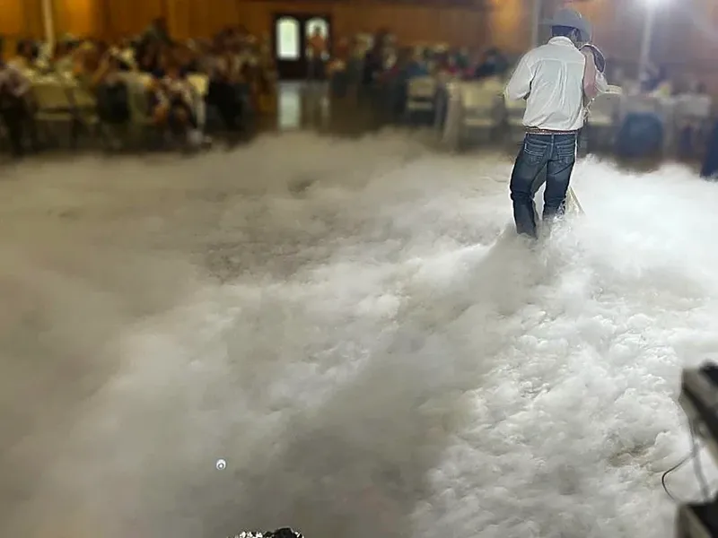 Low-lying dry-ice fog rolling across a reception dance floor.