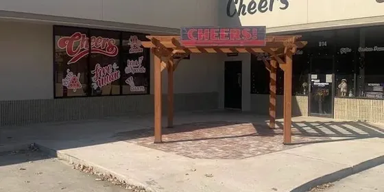 The front of Cheers in Tomball, a single-storey bar with a timber pergola over the entrance.