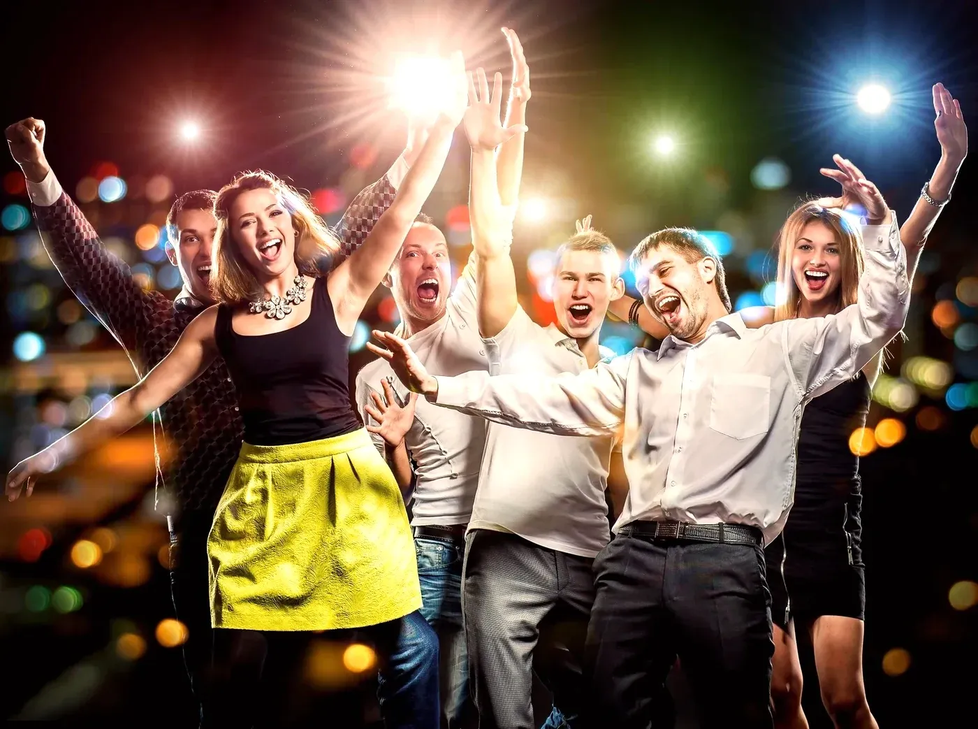 Guests cheering with hands raised and confetti falling at an event.