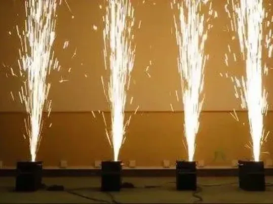 Indoor cold-spark fountains firing upward on a dance floor.